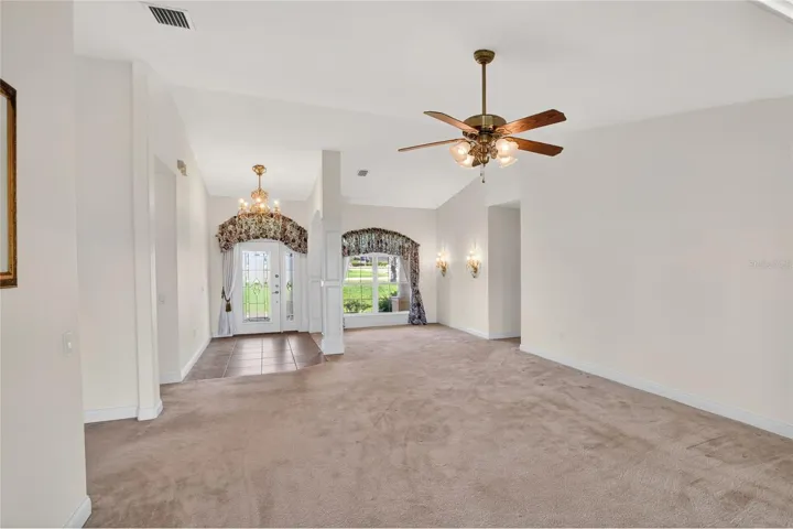 The formal living room sets the tone, where natural light moves easily through the space and carries your view straight out to the lake.