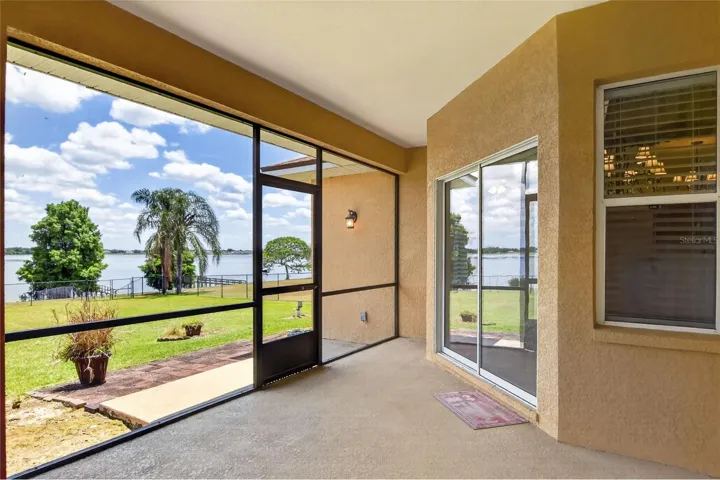 Step off the lanai into the backyard and follow it straight out to the lake, with open space and light leading the way.