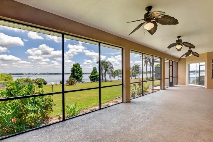 The lanai sits at the center of it all, with the living, dining, family room, and primary suite each opening out to it, keeping the light and lake within reach.