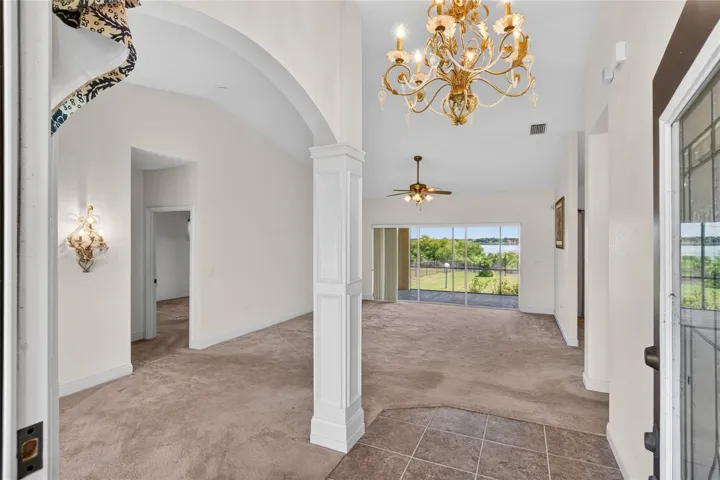 As you step inside, your eye is pulled straight through the home to the lake beyond, with light following the same path in behind it.