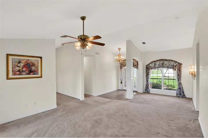 From the primary bedroom, the path leads you back into the living room, where the light and lake draw you in again.