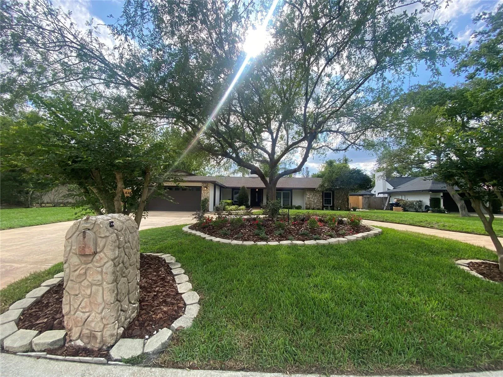 New front yard landscaping and large, semicircular driveway