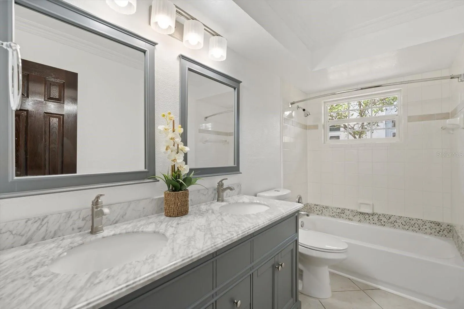 Newer dual sink vanity with stone top and new tub in 2nd bathroom