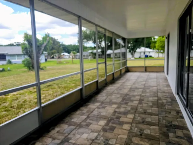 Screened tiled porch with access to the patio.