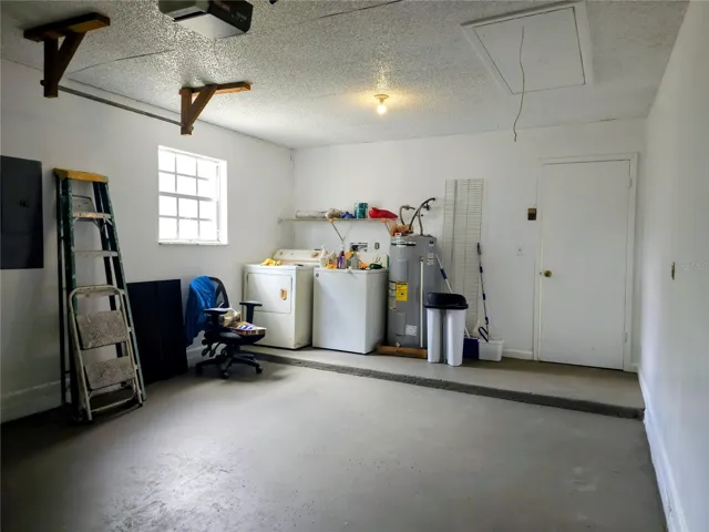 Laundry area is at the back of the garage.