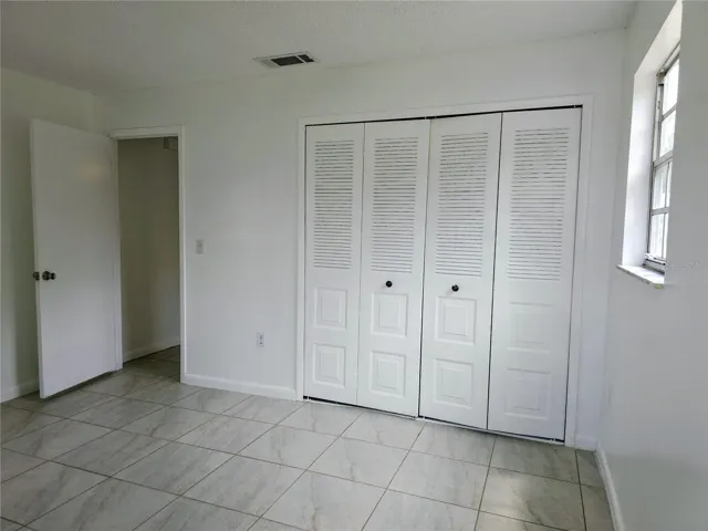 Guest bedroom has a double door closet