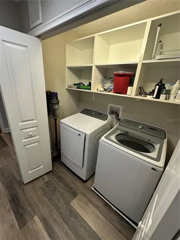 Upstairs laundry closet with built-in cabinets