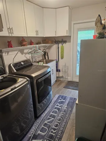 Laundry, washer/drier, and new wall cabinets