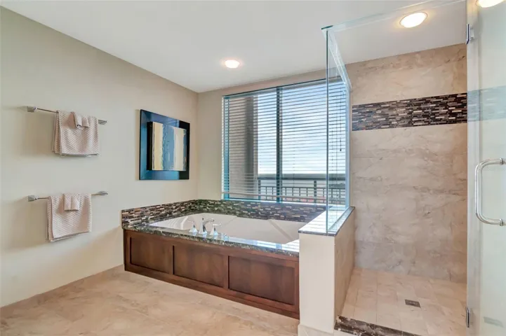 Massive primary bath with large tub with views of intercoastal
