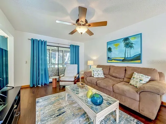 Living Room-Bright and open with Engineered wood flooring and sliders to Florida Room