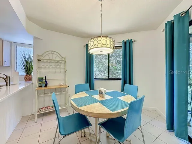 Cafe Nook- Bright eat in area open to Breakfast bar. With the large window and sliders to Florida room this area is very bright with natural lighting