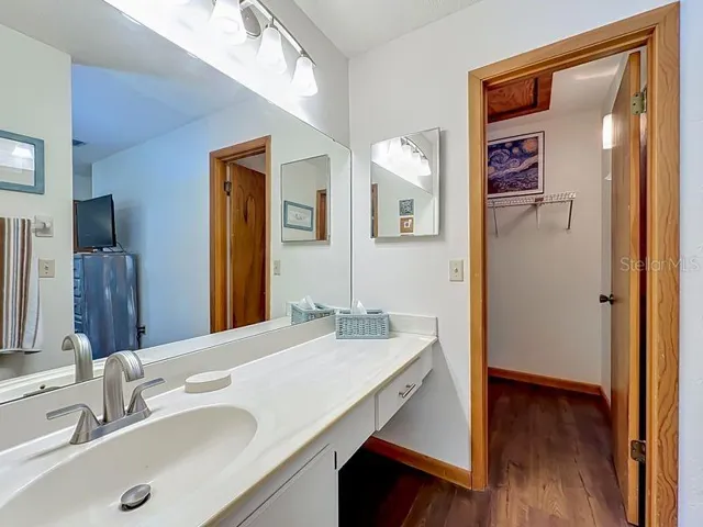 Primary Bathroom. Extended single vanity -full wall mirror-walk in closet