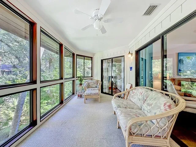 Florida Room overlooking green area Sliders to cafe nook, living room and primary bedroom