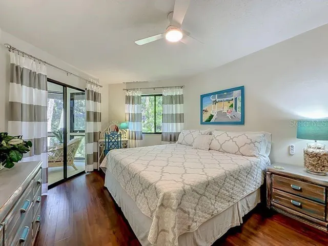 Primary Bedroom: Engineered Wood flooring - Large window and sliders to Florida Room