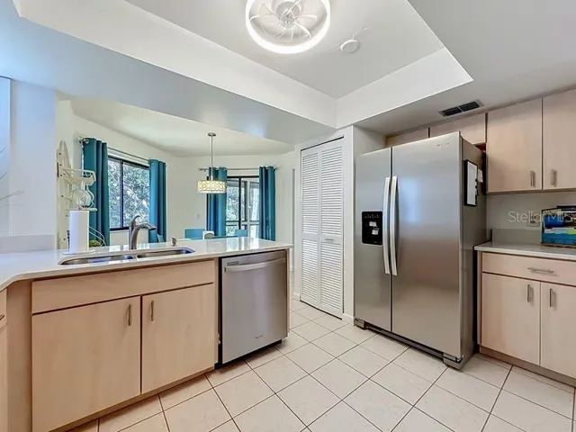 Kitchen High Ceiling -Stainless Steel Appliances-Pantry and stackable washer and Dryer closet.