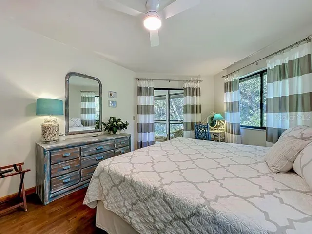 Primary Bedroom: Engineered Wood flooring - Large window and sliders to Florida Room