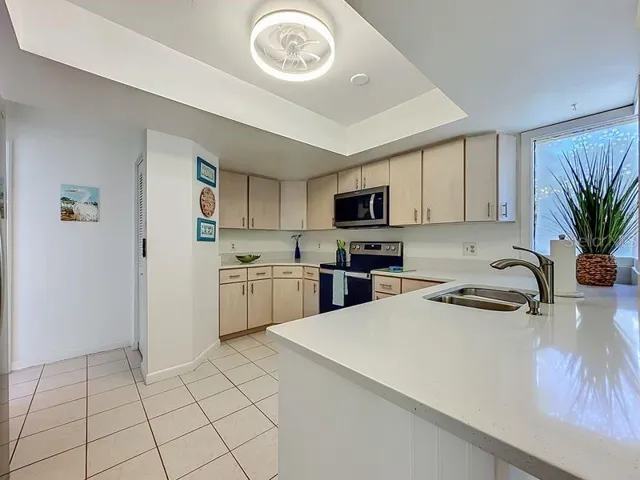 Kitchen High Ceiling -Stainless Steel Appliances-Pantry and stackable washer and Dryer closet.