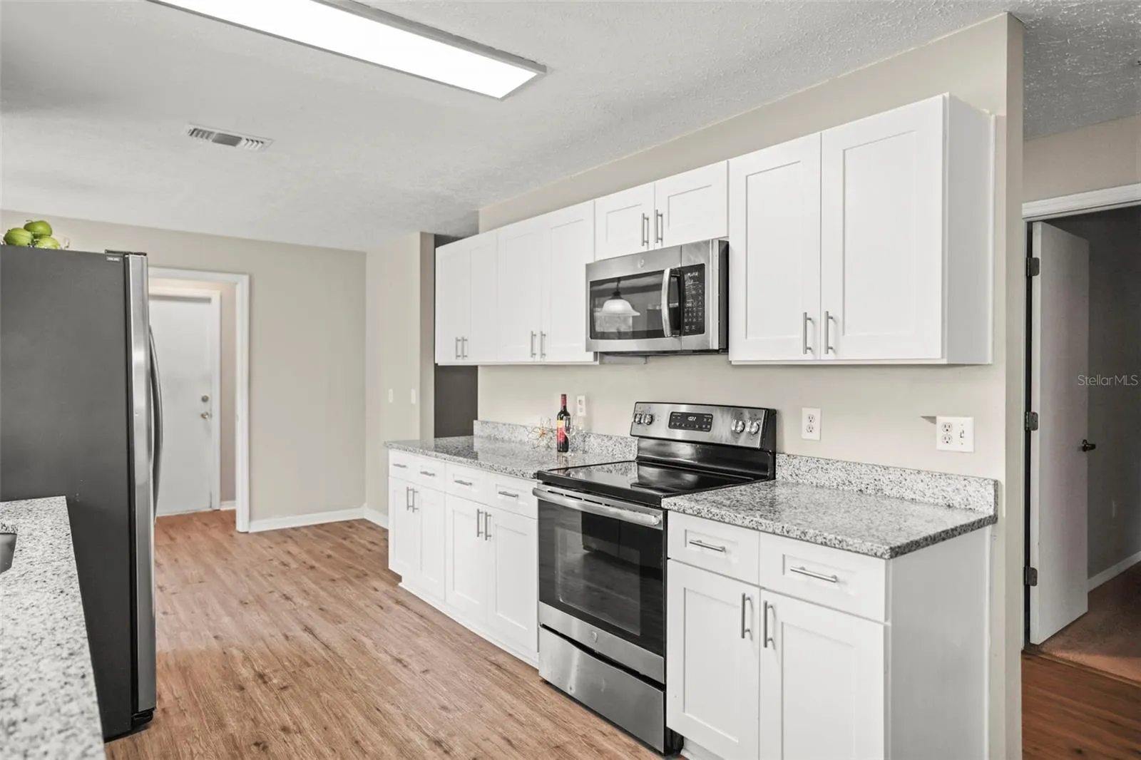 White Cabinets, Granite Counters, and Stainless-Steel Appliances