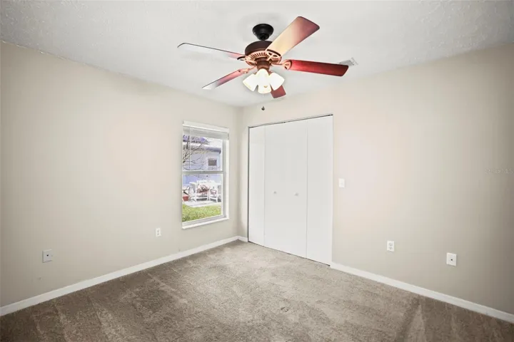 Bedroom 2 with carpeting and built in closet.