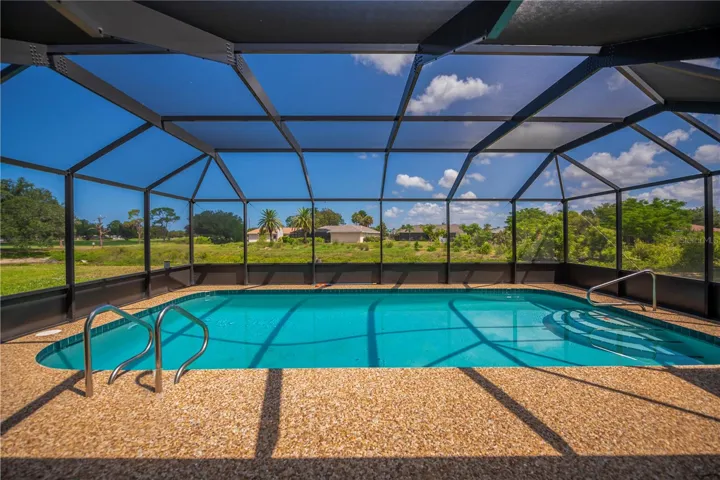Pool overlooks the golf course, pond, and Jacaranda Eco-Preserve