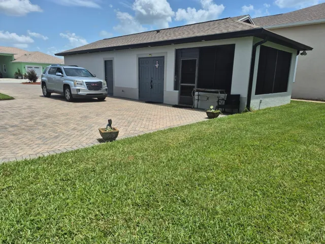 Entry and bricked driveway.
