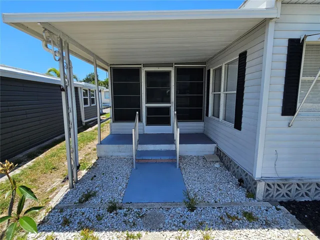 Back covered porch and entrance to Florida room