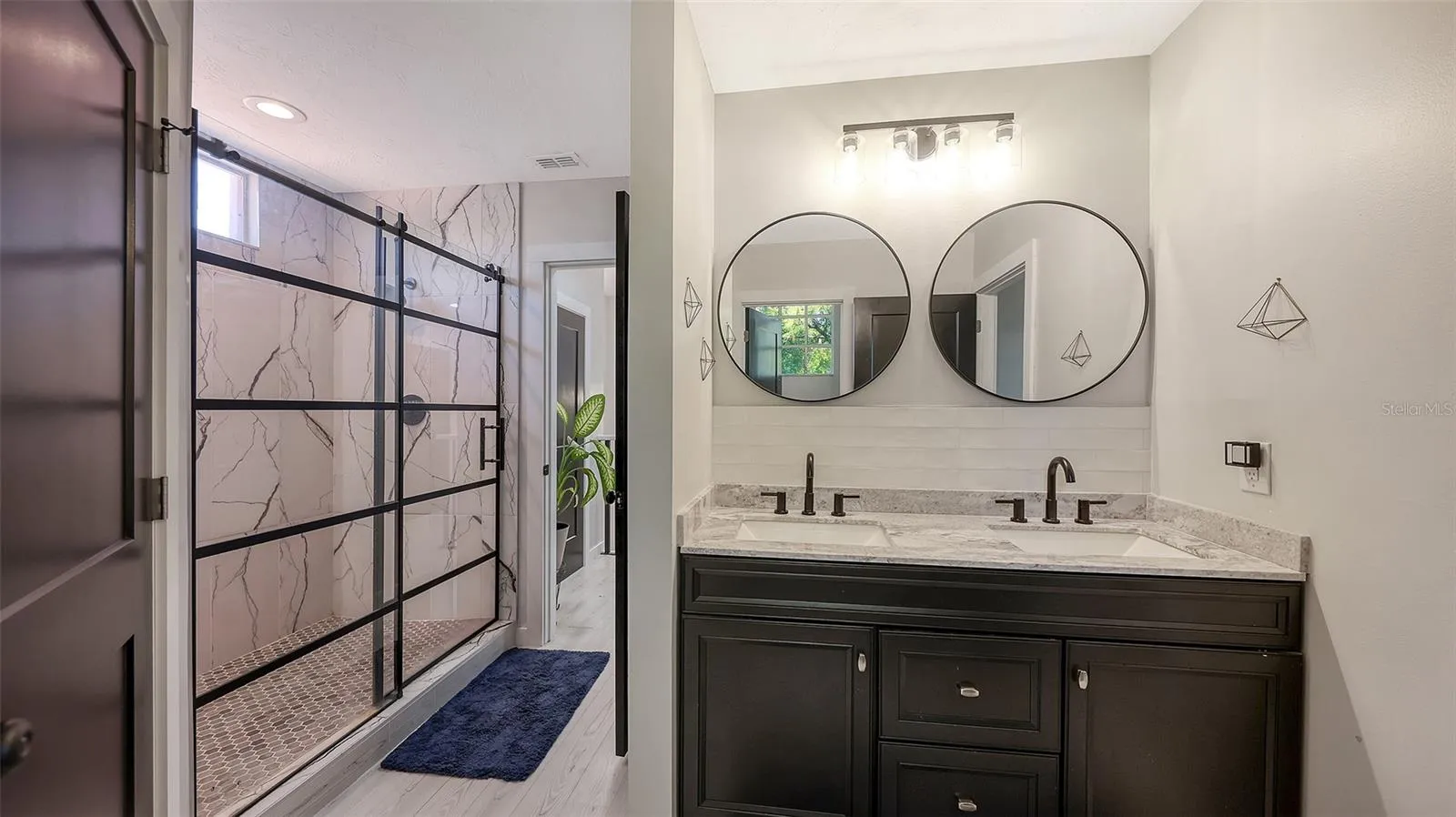 An oversized walk-in shower adds to the serenity of the bath.