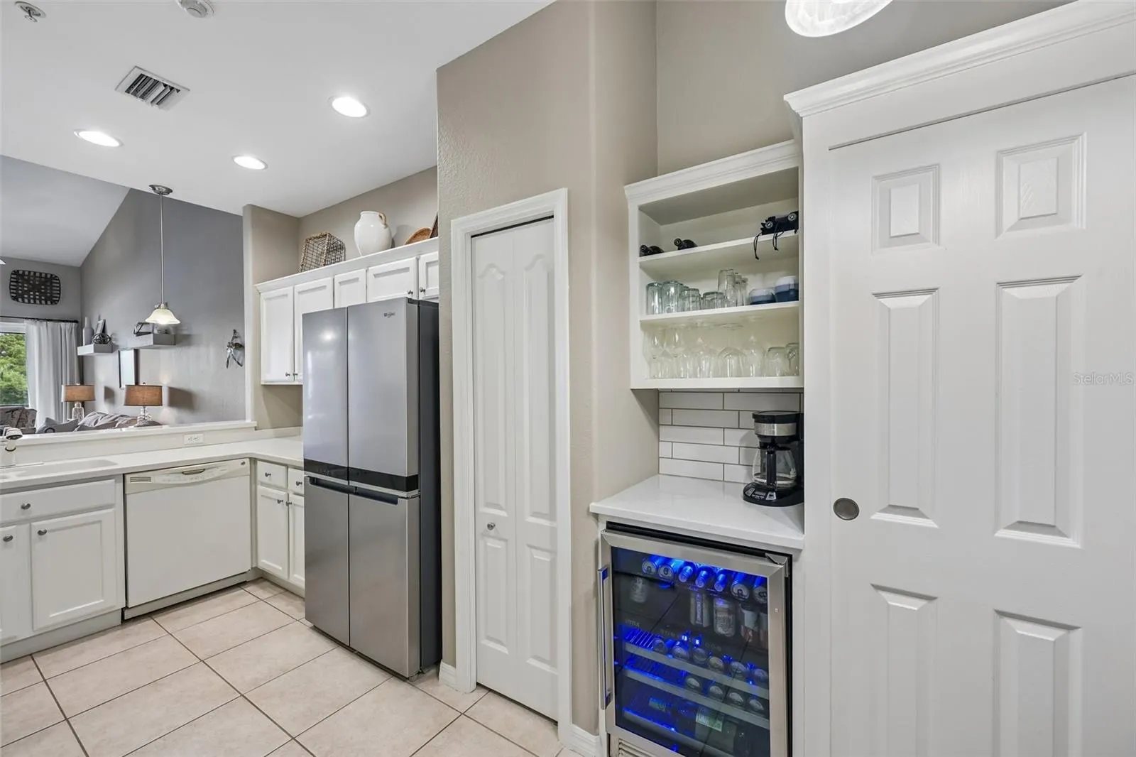 KITCHEN WITH STAINLESS APPLIANCES AND BEER &amp; WINE BAR BUILT IN