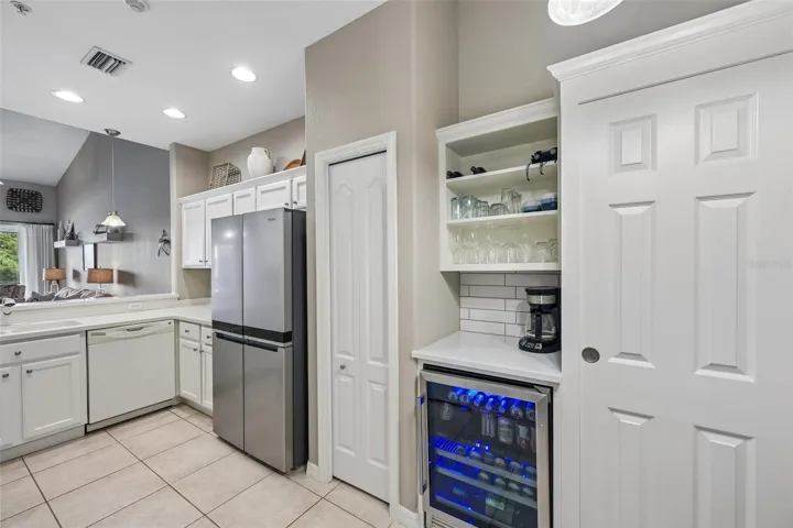 KITCHEN WITH STAINLESS APPLIANCES AND BEER &amp; WINE BAR BUILT IN
