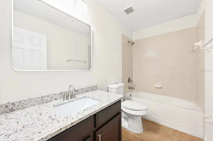Two additional bedrooms, a full bath, and a convenient LAUNDRY CLOSET complete the upper level.