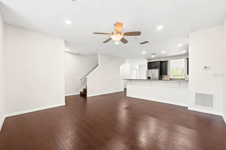 The Living Room, Dining area, and Kitchen flow seamlessly together, enhanced by ABUNDANT NATURAL LIGHT.