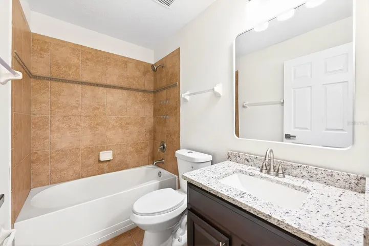 The first floor features a private bedroom with its own EN SUITE BATH, making it ideal for guests, a home office, or a COMFORTABLE IN-LAW SUITE.