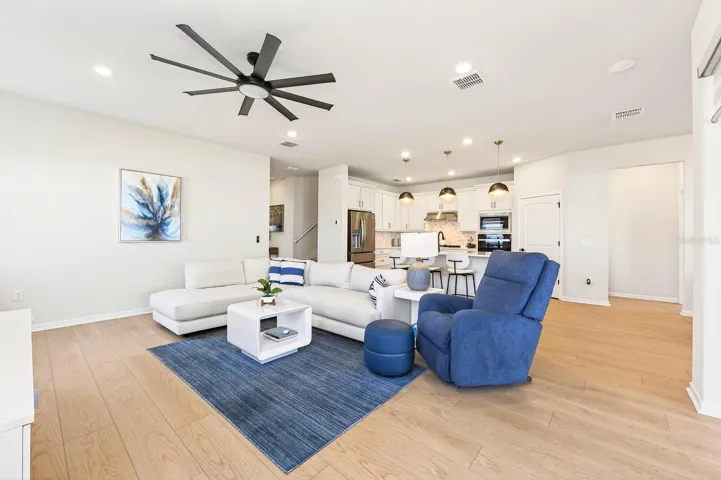 The spacious Living Room conveniently adjacent to the Kitchen, provides a comfortable gathering space with an open and airy feel.