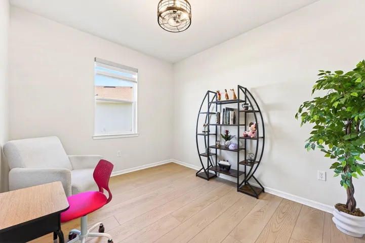 A FLEXIBLE OFFICE SPACE behind glass French doors that can easily serve as a fourth bedroom.