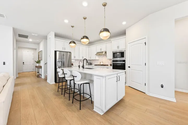 Inside, you’ll find a bright, open-concept design enhanced by LUXURY VINYL PLANK FLOORING that flows seamlessly through the Living Room, Dining area, and Kitchen.