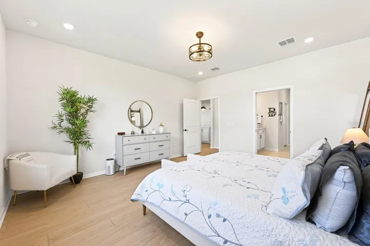 The Primary Suite, located on the main floor, offers a private retreat with ABUNDANT NATURAL LIGHT and serene backyard views.