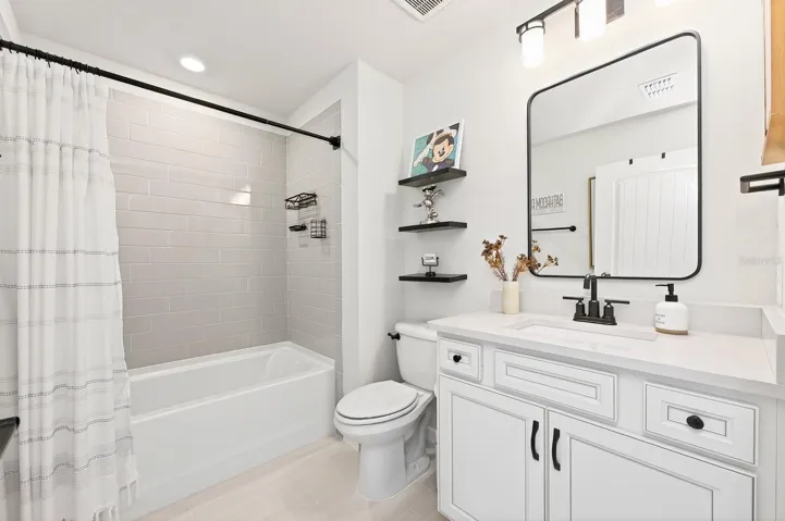 An ADDITIONAL BEDROOM AND FULL BATH upstairs provide the perfect setup for guests.