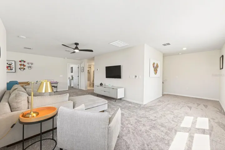 Upstairs, a GENEROUS LOFT AREA offers incredible versatility, currently enhanced with a CUSTOM COFFEE BAR (2025) and large enough to accommodate additional living, entertaining, or even a future bedroom while still maintaining open loft space.