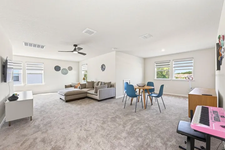 Upstairs, a GENEROUS LOFT AREA offers incredible versatility, currently enhanced with a CUSTOM COFFEE BAR (2025) and large enough to accommodate additional living, entertaining, or even a future bedroom while still maintaining open loft space.