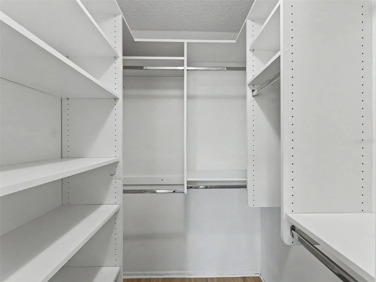 Custom closet organizers in both bedrooms