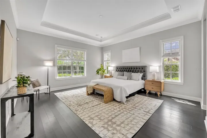 Primary suite with tile floors & backyard views