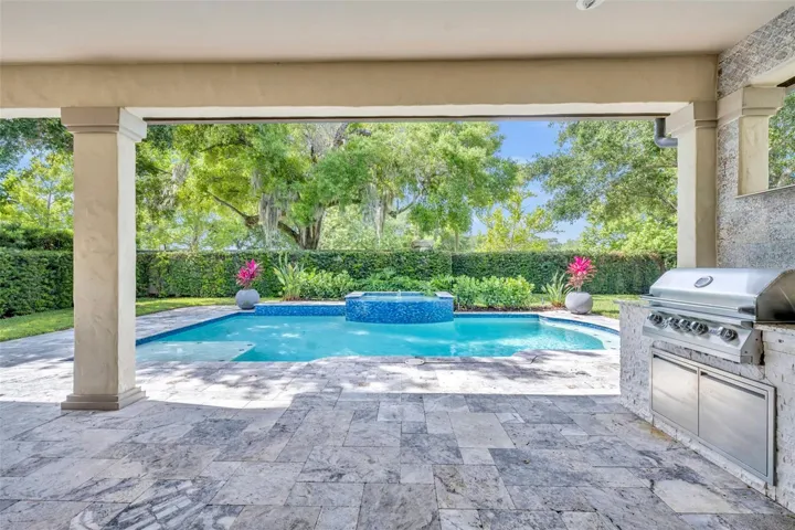 Travertine tile extends around pool deck
