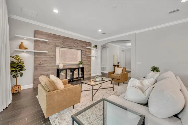 Living room with floating shelves & feature wall