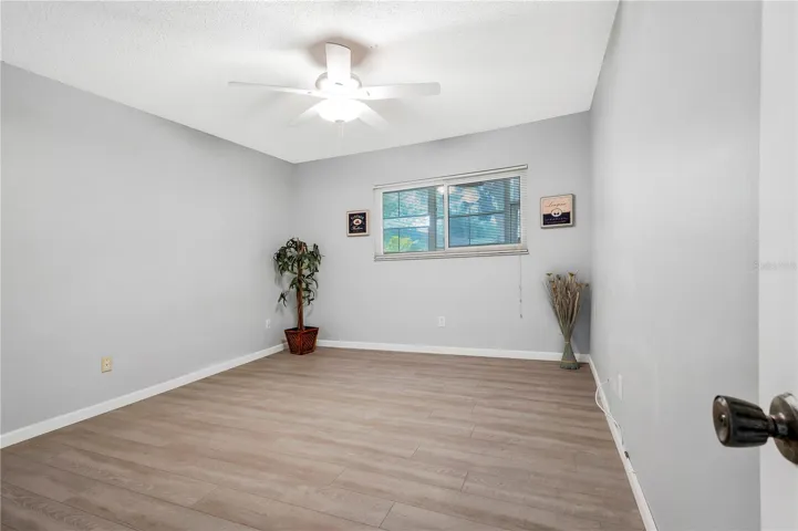Primary Bedroom with ceiling fan and window