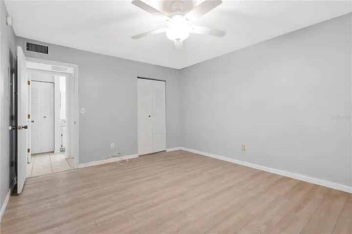 Primary Bedroom with walk in closet and ceiling fan