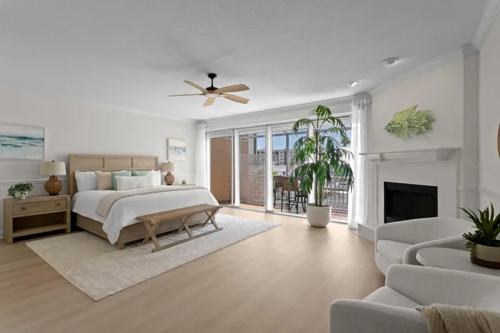 Large Primary suite with fireplace and sliders to private screened in balcony with water views