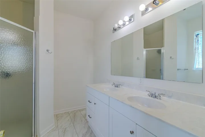 Master Bathroom with a double sink vanity and walk-in shower.