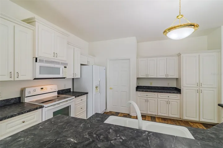 View of open kitchen area with ample countertops for entertaining.