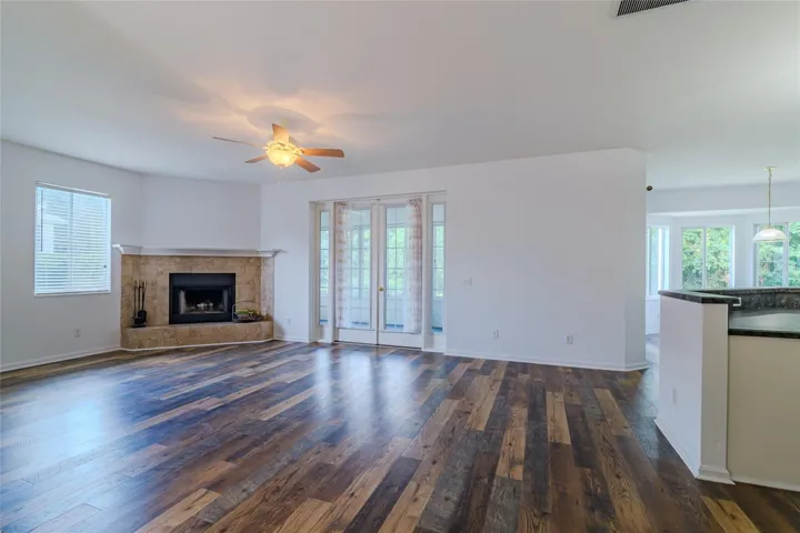 Living Room with fireplace, French doors leading to Florida room and open kitchen area