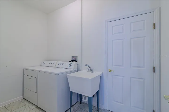 Inside laundry room with utility sink and close to the garage